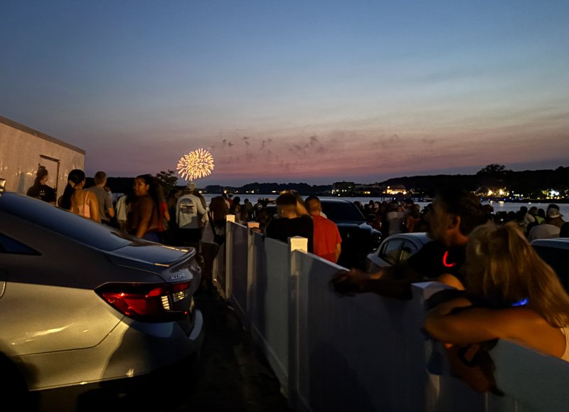 Fireworks can be seen in the distance in another town as folks wait near Northbeach for the Dewey Beach fireworks display to begin.